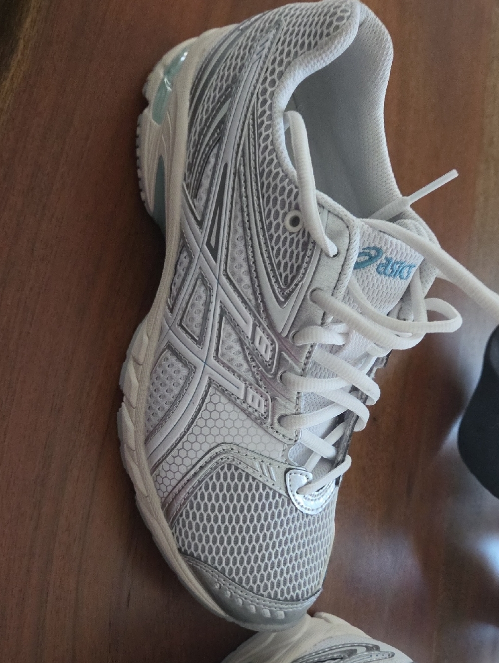ASICS White Athletic Running Shoe with Light Blue Accents - Worn Indoors